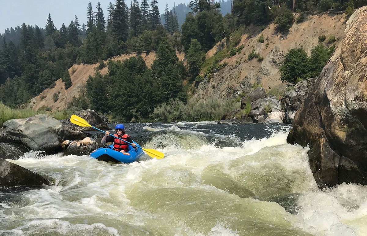 teenage boy inflatable kayaking on middle klamath river