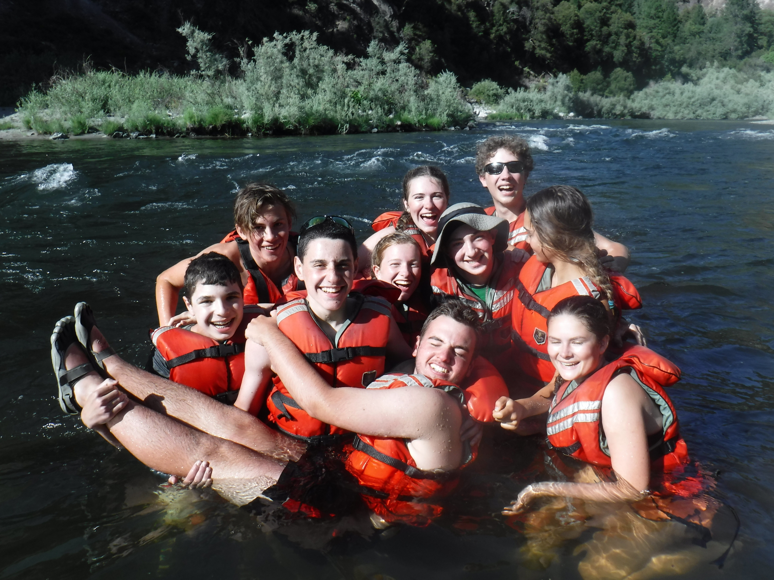 teenagers wearing life jackets in river in california