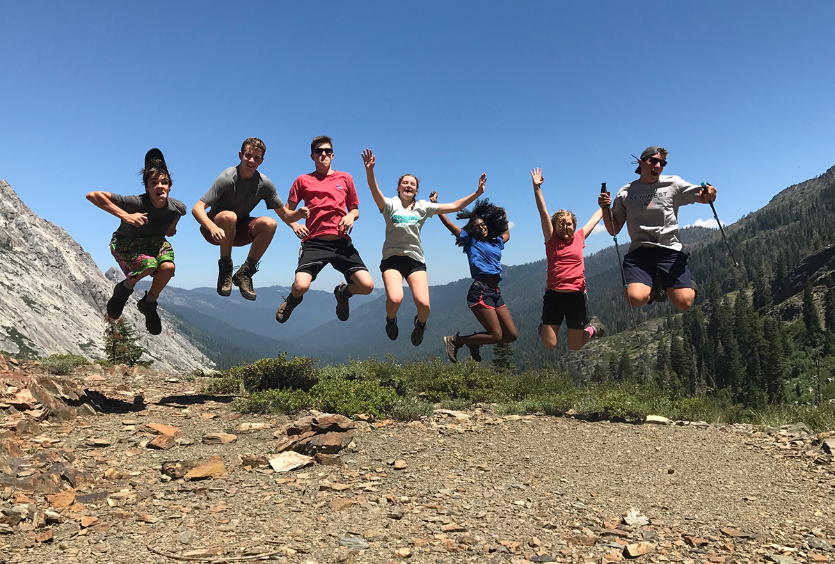 teenagers jumping in the air california hiking