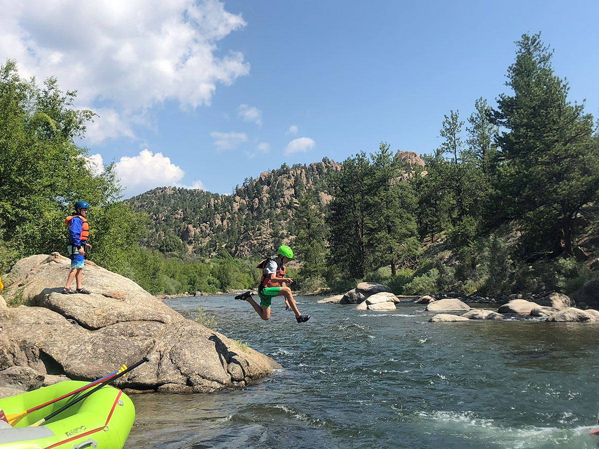 teenage boys jumping into colorado river