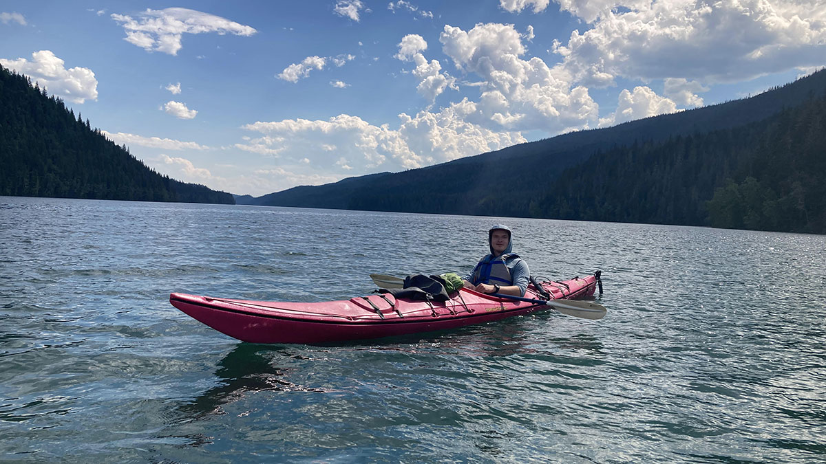 man in a canoe on a lake in canada