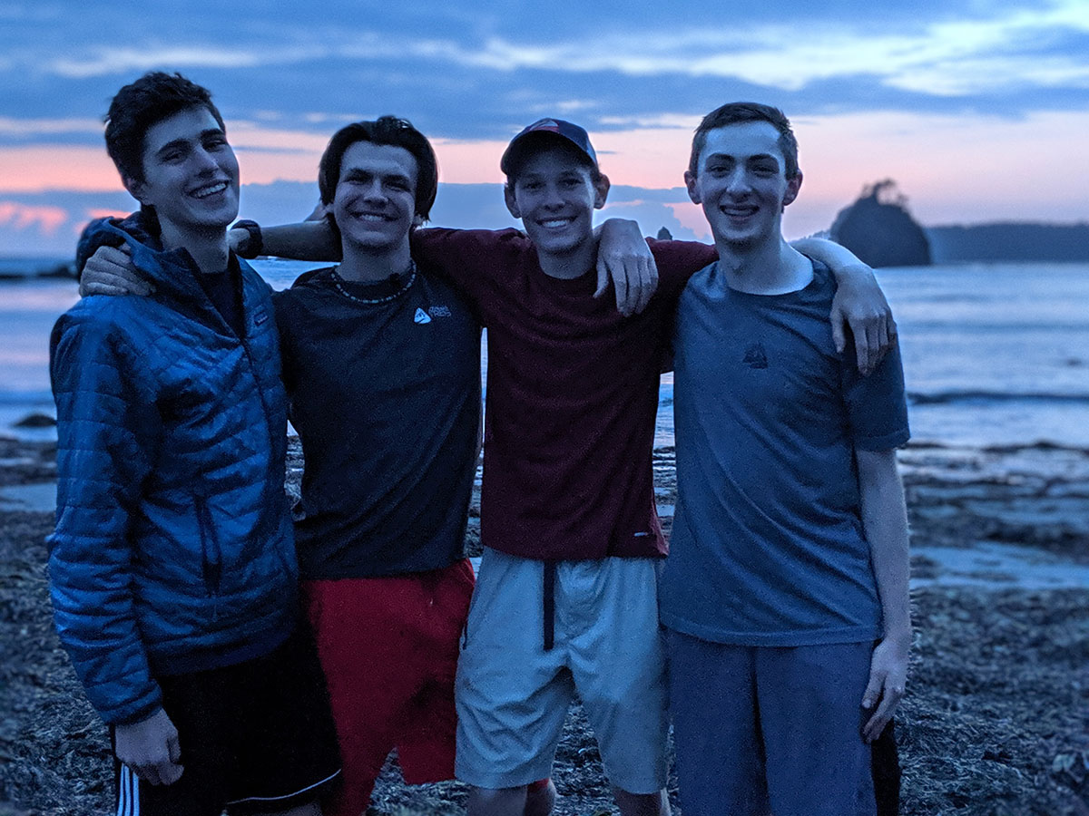 teenage boys backpacking hiking olympic coast washington