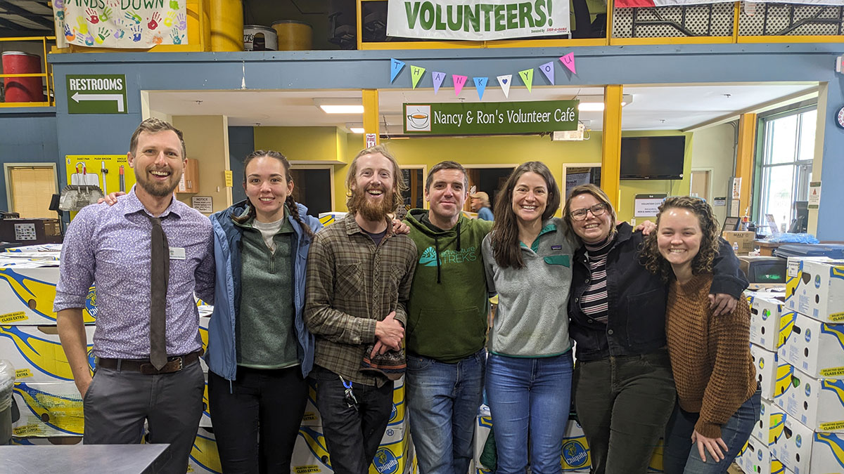 adults standing in a line at manna foodbank